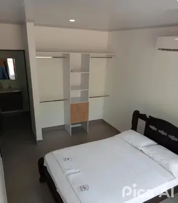 a bedroom with a bed and a room with a closet at casa de vacaciones tierra bomba cartagena de indias in Tierra Bomba