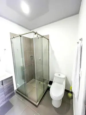 a bathroom with a toilet and a glass shower at casa de vacaciones tierra bomba cartagena de indias in Tierra Bomba
