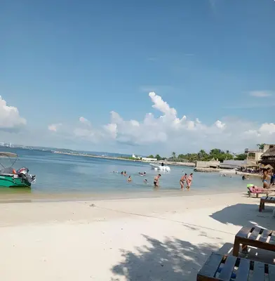 a group of people playing in the water on a beach at casa de vacaciones tierra bomba cartagena de indias in Tierra Bomba