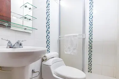 a bathroom with a sink and a toilet and a shower at Ayenda Casa Amarilla in Santa Marta