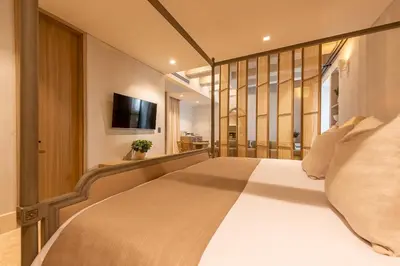a bedroom with a large bed and a television at Cinco Quintas Hotel Boutique in Cartagena de Indias