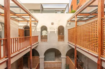 an internal view of a building with arches and wooden railing at Cinco Quintas Hotel Boutique in Cartagena de Indias