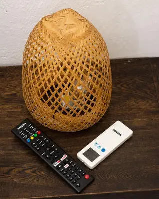a wicker ball and two remote controls on a table at Hb3 Double Room with private bathroom facing the sea in Cartagena de Indias