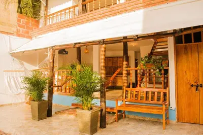 a house with a porch with a bench and plants at Hb4 Double Room with Private Bathroom and Balcony in Cartagena de Indias