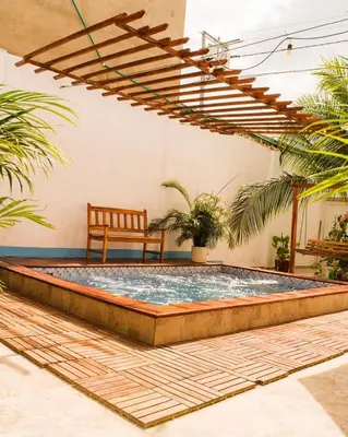 a pool in the middle of a patio with a bench at Hb4 Double Room with Private Bathroom and Balcony in Cartagena de Indias