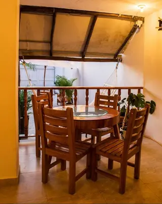 a dining room table and chairs with a glass top at Hb4 Double Room with Private Bathroom and Balcony in Cartagena de Indias