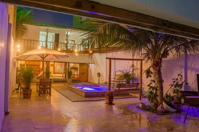 a house with a swimming pool and a palm tree at Hb4 Double Room with Private Bathroom and Balcony in Cartagena de Indias