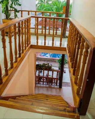 a stairway with a wooden railing and a stair case at Hb1 Triple Room With Air Conditioning And WIFI in Cartagena de Indias