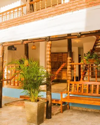 a porch of a house with a bench and stairs at Hb1 Triple Room With Air Conditioning And WIFI in Cartagena de Indias
