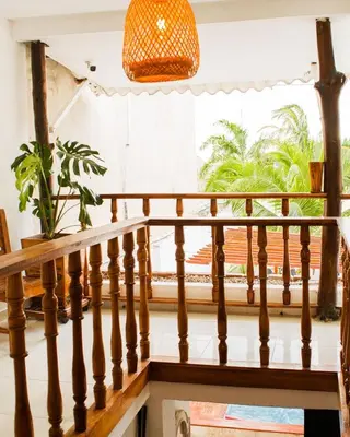a staircase in a house with a window and a potted plant at Hb2 Triple Room with shared bathroom in Cartagena de Indias