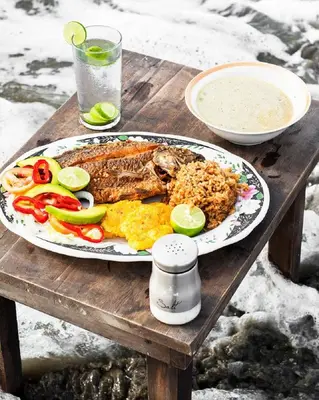a plate of food on a wooden table at Hb2 Triple Room with shared bathroom in Cartagena de Indias