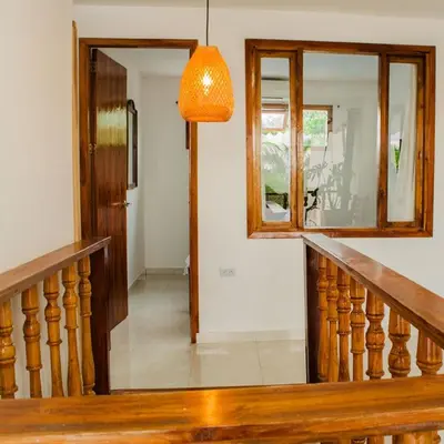 a hallway with a wooden staircase and a mirror at Hb2 Triple Room with shared bathroom in Cartagena de Indias
