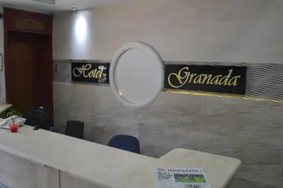 a mirror on a wall with a sign in a room at Hotel Granada Inn in Barranquilla