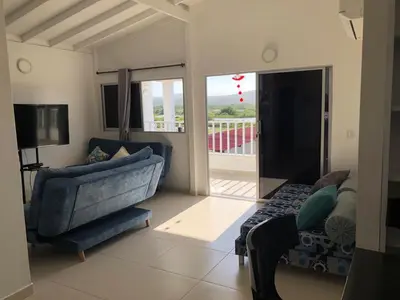 a living room with a blue couch and a tv at Casa Bita Morales CASA 201 in Cartagena de Indias