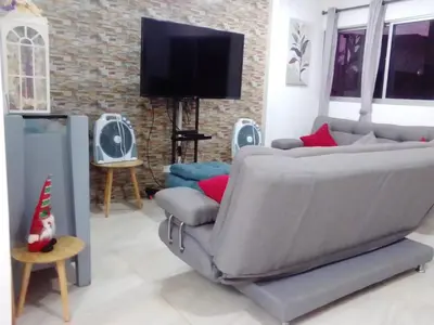 a living room with a couch and a flat screen tv at Casa Bita Morales CASA 201 in Cartagena de Indias