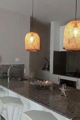 a kitchen with a counter with a sink and two lights at Apartamento de lujo Morros ULTRA con vista y acceso directo al mar , Cartagena de Indias in Cartagena de Indias