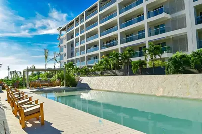 a hotel with a swimming pool next to a building at Hermoso y con acceso directo a la playa! in Cartagena de Indias
