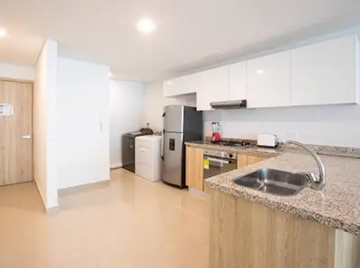 a kitchen with white cabinets and a stainless steel refrigerator at Acogedor Marbella ideal familias mínimo 2 días in Cartagena de Indias