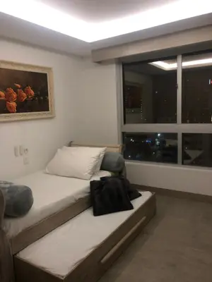 a bedroom with a bed and a large window at Apartamento Fantástico in Cartagena de Indias