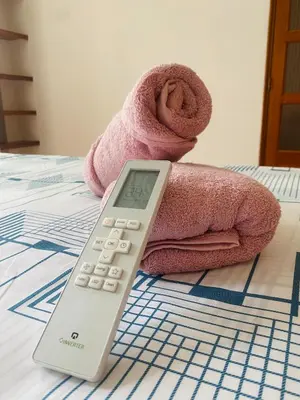 a thermometer sitting on a bed next to a towel at Cartagena Kings Hostel in Cartagena de Indias