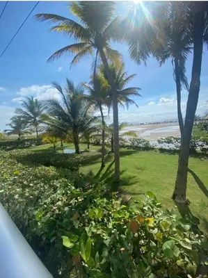 a view of a beach with palm trees and grass at Apartamento completo vacacional in Cartagena de Indias
