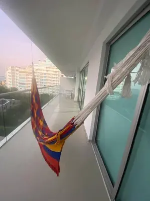 a colorful hammock hanging from a window of a building at Apartamento completo vacacional in Cartagena de Indias