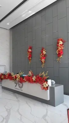a long table with flowers on a wall at Distrito 90 in Barranquilla