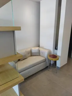 a living room with a couch and a stool at Distrito 90 in Barranquilla
