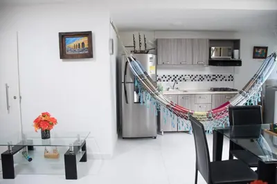 a kitchen with a hammock in front of a refrigerator at Apartamento en Caribe campestre Coveñas in Coveñitas