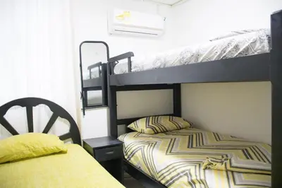 a bedroom with two bunk beds and a bed at Apartamento en Caribe campestre Coveñas in Coveñitas
