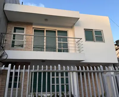 a house with a white fence in front of it at Apartamento la Isla 2-Coveñas in Coveñas