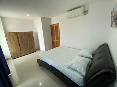 a bedroom with a bed in a white room at Apartamento la Isla 2-Coveñas in Coveñas