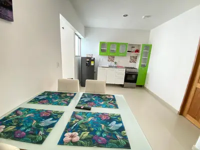 a kitchen with a table with a flower pattern on it at Apartamento la Isla 2-Coveñas in Coveñas