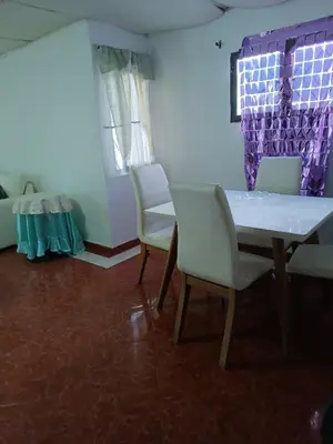 a dining room with chairs and a table and a window at Beach Airport House in Cartagena de Indias