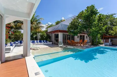 a swimming pool next to a house at dhozt Marlinda Beach House. Cartagena Colombia in Cartagena de Indias