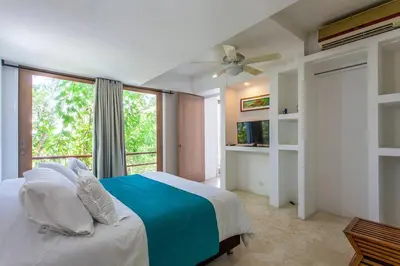a bedroom with a bed and a large window at dhozt Marlinda Beach House. Cartagena Colombia in Cartagena de Indias