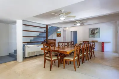 a dining room with a table and chairs and a staircase at dhozt Marlinda Beach House. Cartagena Colombia in Cartagena de Indias