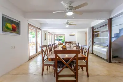 a dining room with a table and chairs and a ceiling fan at dhozt Marlinda Beach House. Cartagena Colombia in Cartagena de Indias