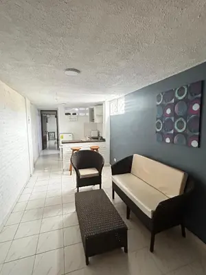 a living room with a couch and a table at Hotel Boston Superior in Barranquilla