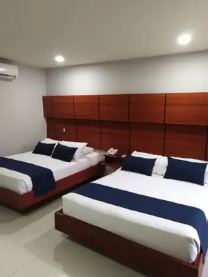 two beds in a hotel room with two beds sidx sidx sidx at Hotel Caribe 79 in Barranquilla