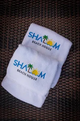 two towels with the words shahi beach house on them at Amazing Beach House 13BR w/Pool & Staff in Cartagena de Indias