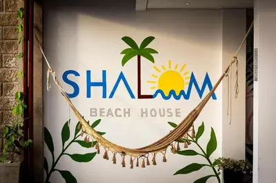a sign for a beach house with a hammock at Amazing Beach House 13BR w/Pool & Staff in Cartagena de Indias