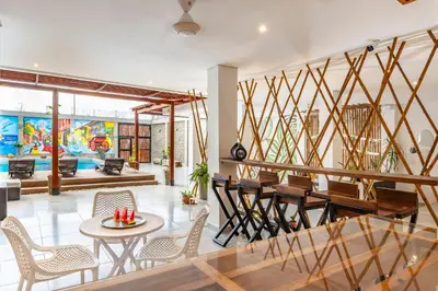 a living room with a table and chairs at Amazing Beach House 13BR w/Pool & Staff in Cartagena de Indias