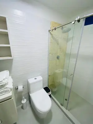 a bathroom with a toilet and a glass shower at Casa Playa James in La Boquilla