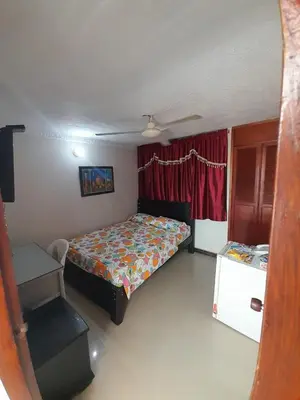 a small bedroom with a bed and a window at Hotel Colonial Inn in Barranquilla
