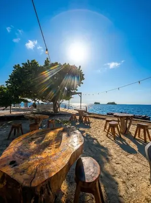 a group of picnic tables on the beach at Tintipan Hotel in Tintipan Island