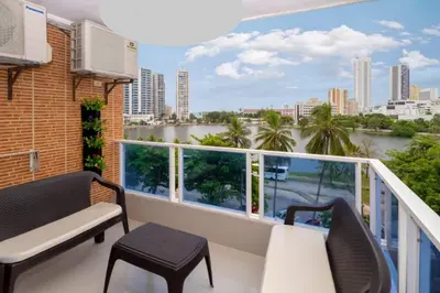 a balcony with a view of a river and buildings at AL-1C APARTAMENTO DE 1 ALCOBA CERCA AL MAR AIRE ACONDICIONADO WIFi Y PISCINA in Cartagena de Indias