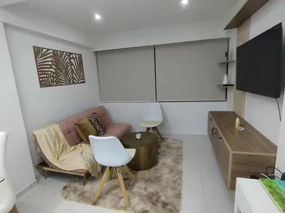 a living room with a couch and a tv at Apartamento moderno frente al mar in Cartagena de Indias