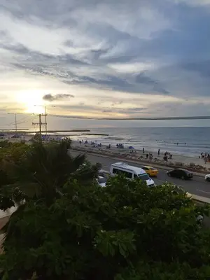 a view of a beach with a van parked on a road at Apartamento moderno frente al mar in Cartagena de Indias
