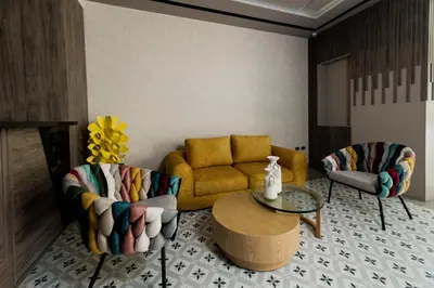 a living room with a couch and a table and chairs at Amari Living Suites in Barranquilla